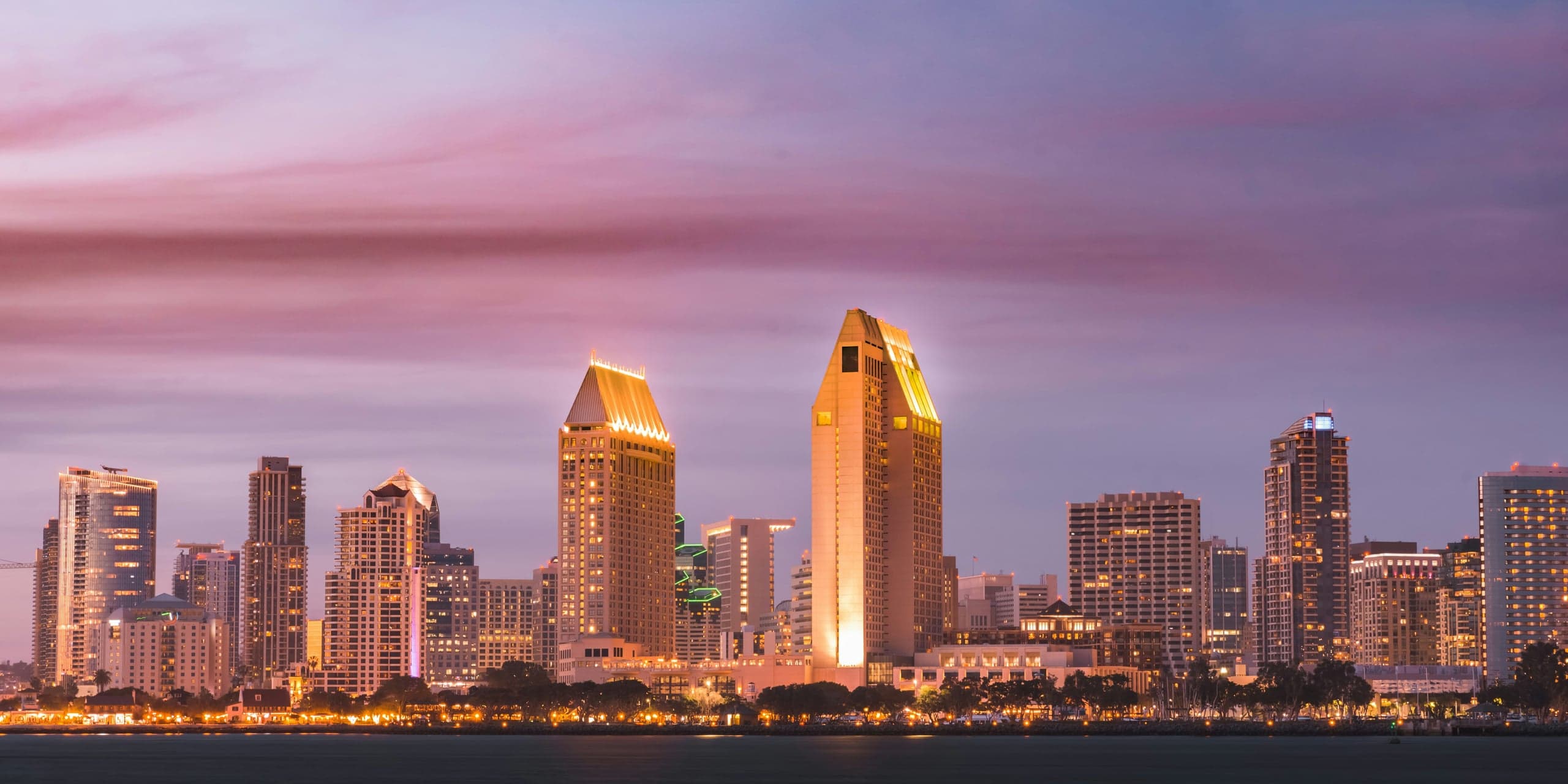 The downtown San Diego skyline at dusk across San Diego Bay